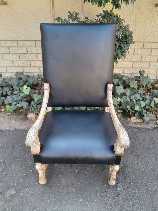 An Antique Ornately Carved Oak Throne Armchair Upholstered in Leather and in a Contemporary Bleac...