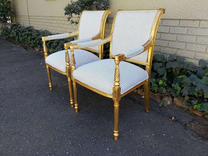 A Pair Of Carved And Gilded Armchairs