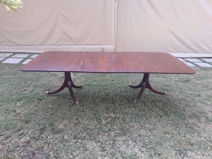 A 20th Century Mahogany Dining Table with Two Extensions and Brass Feet & Casters