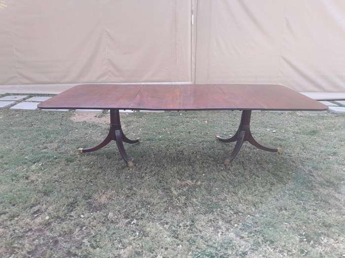 A 20th Century Mahogany Dining Table with Two Extensions and Brass Feet & Casters