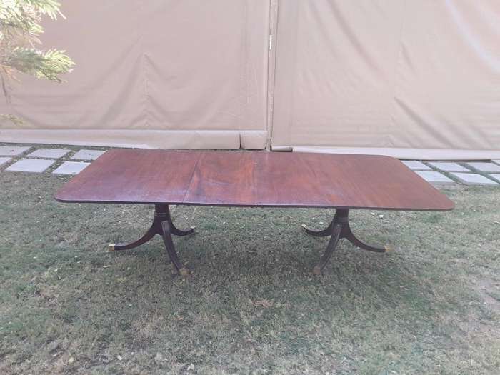 A 20th Century Mahogany Dining Table with Two Extensions and Brass Feet & Casters