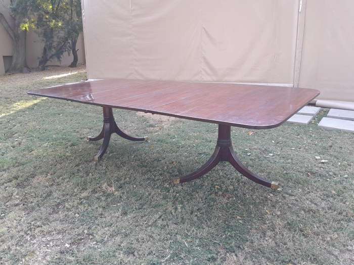 A 20th Century Mahogany Dining Table with Two Extensions and Brass Feet & Casters