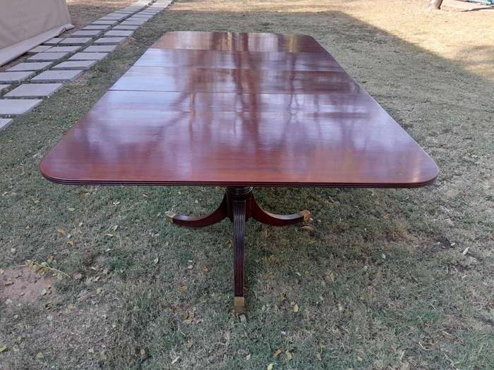 A 20th Century Mahogany Dining Table with Two Extensions and Brass Feet & Casters