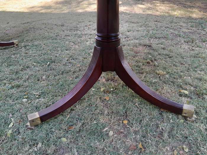 A 20th Century Mahogany Dining Table with Two Extensions and Brass Feet & Casters