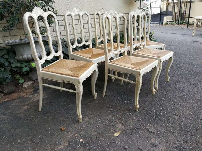A 20TH Century French Set of Six Carved Dining Chairs with Rush Seats in a Contemporary Bleached ...