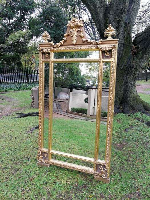 A French Style Ornately Carved and Gilded Bevelled Mirror
