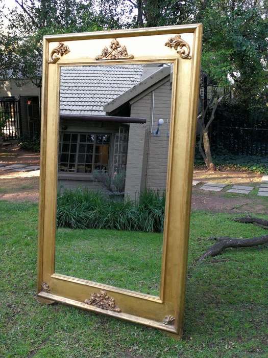 A French Style Ornately Carved and Gilded Bevelled Mirror