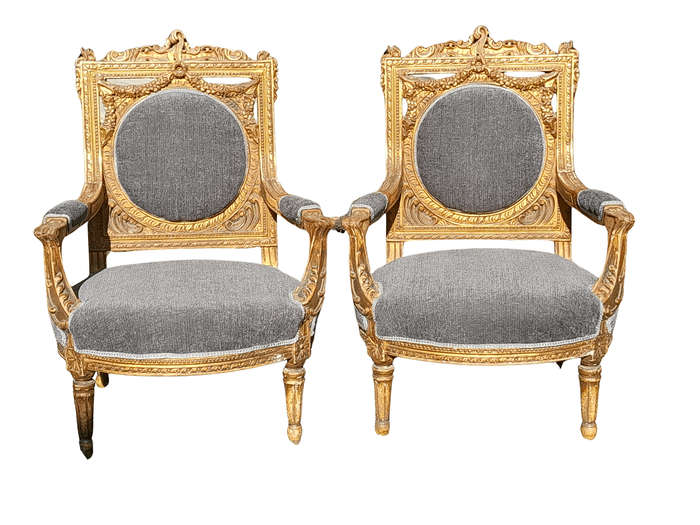 A 20th Century French Style Ornately Carved and Gilded Pair of Arm Chairs