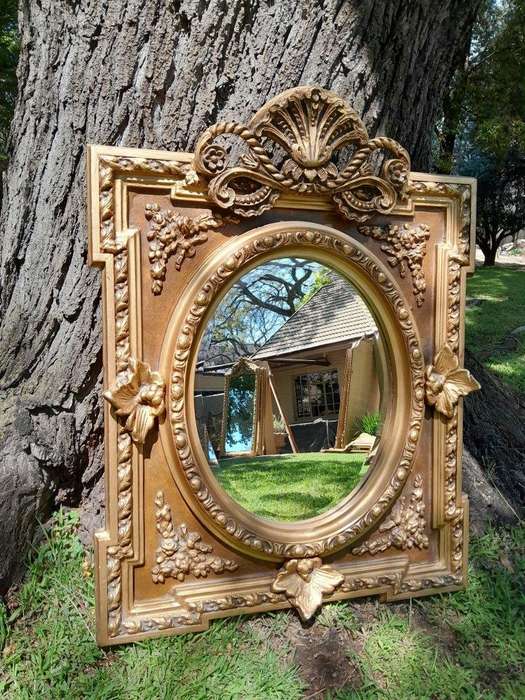 A 20th Century French Style Ornately Carved and Gilded Bevelled Mirror
