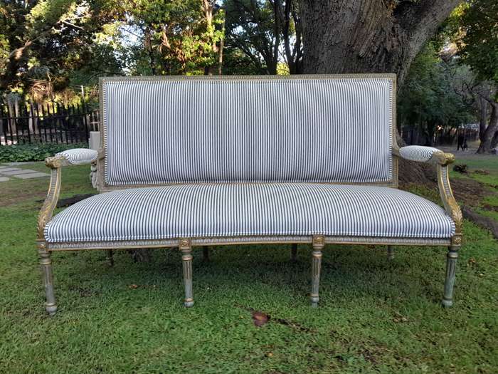 A 20th Century French  Style Carved and Hand Gilded Settee Upholstered in Ticking Fabric