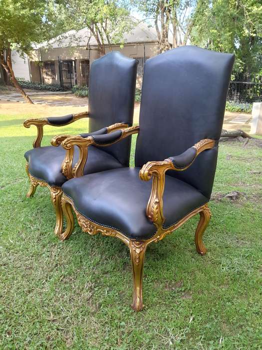 A 20TH Century Pair Of French Style Carved and Giltwood High Back Armchairs Upholstered in Leather