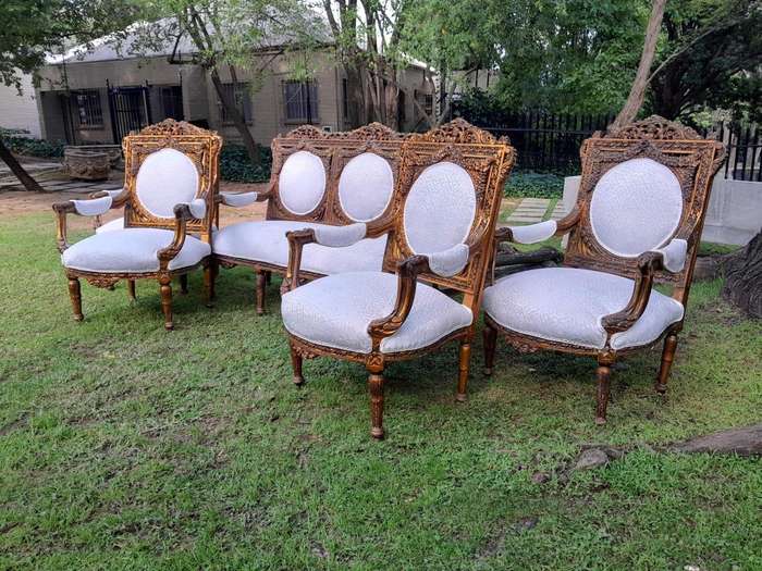 A 20th Century French Louis XVI Style Five Piece Set of Giltwood Settee and Four Armchairs