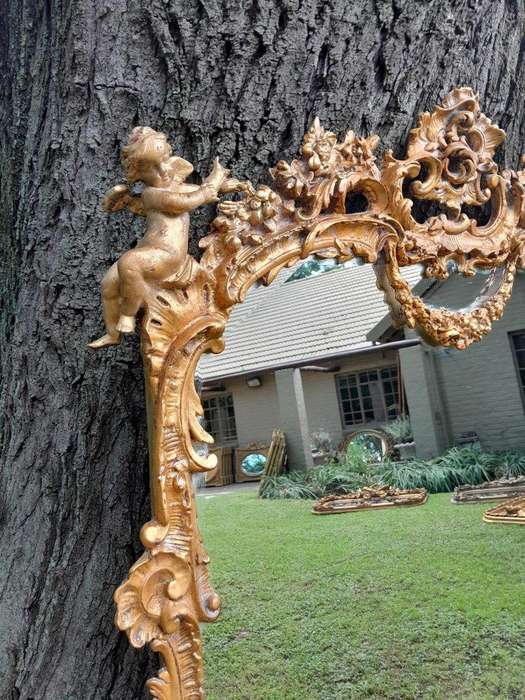 A French Rococo Style Ornately Carved and Gilded Bevelled Mirror 1