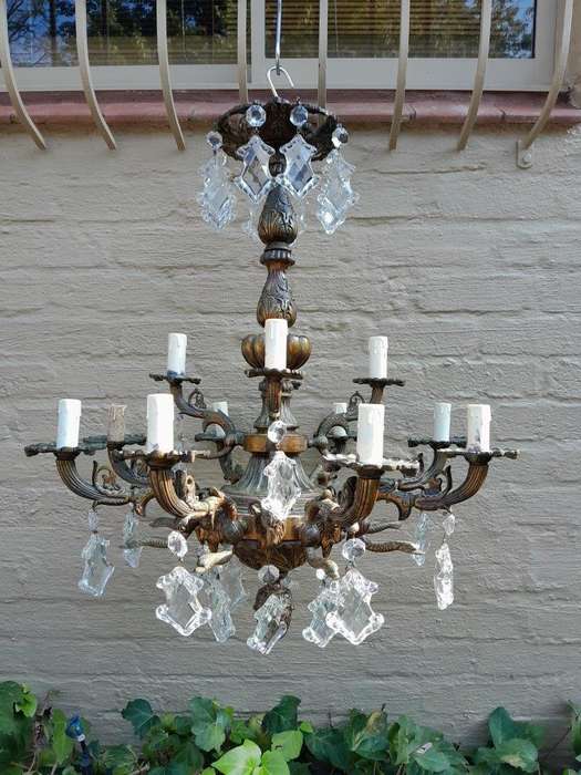 A 20th Century French Style Antique Brass and Crystal Twelve Light Chandelier