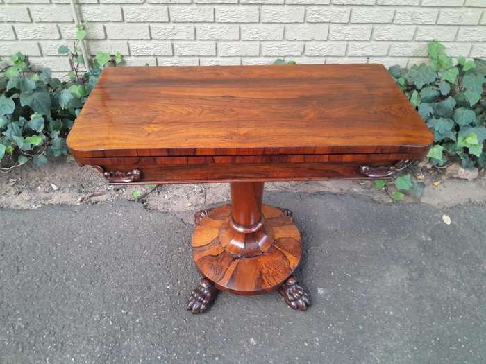 A 19TH Century William IV Rosewood Fold-over Card Table With Paw Feet