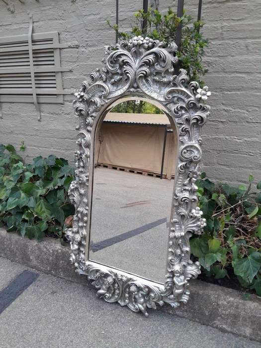 A 20th Century Ornately Carved, Bevelled and Gilt Mirror