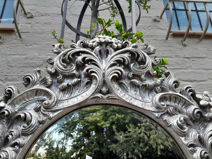 A 20th Century Ornately Carved, Bevelled and Gilt Mirror