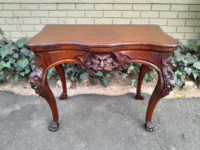 An Antique Jacobean Ornately Carved Oak Card Table with Black Baize