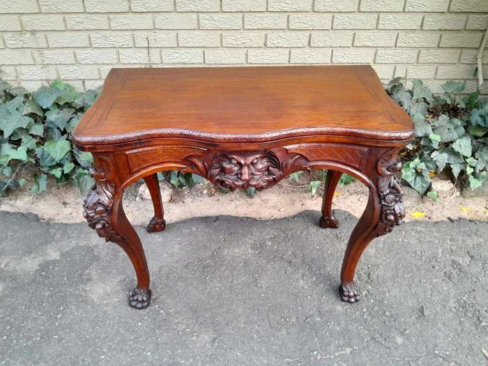 An Antique Jacobean Ornately Carved Oak Card Table with Black Baize