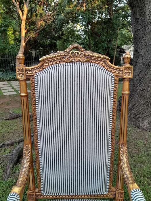 A Pair of French Rococo Style Ornately Carved Giltwood Arm Chairs Upholstered in a Contemporary T...