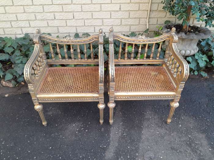 A 20th Century French Style Pair of Ornately Carved and Rattan Arm Chairs