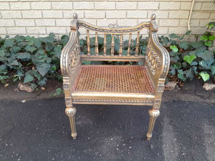A 20th Century French Style Pair of Ornately Carved and Rattan Arm Chairs