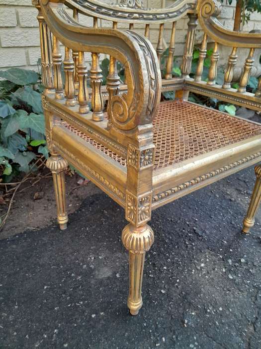 A 20th Century French Style Pair of Ornately Carved and Rattan Arm Chairs