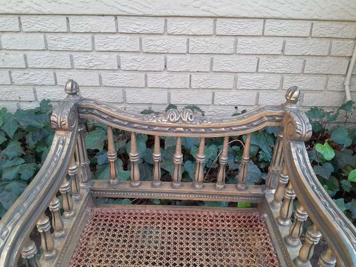 A 20th Century French Style Pair of Ornately Carved and Rattan Arm Chairs