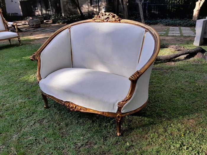 A French Style Ornately Carved and Gilded Bergere Chair