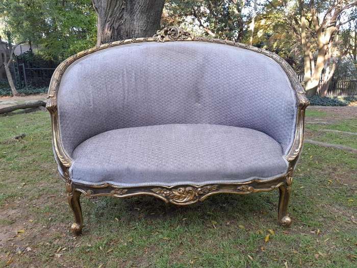 A French Style Ornately Carved and Gilded Bergere Chair