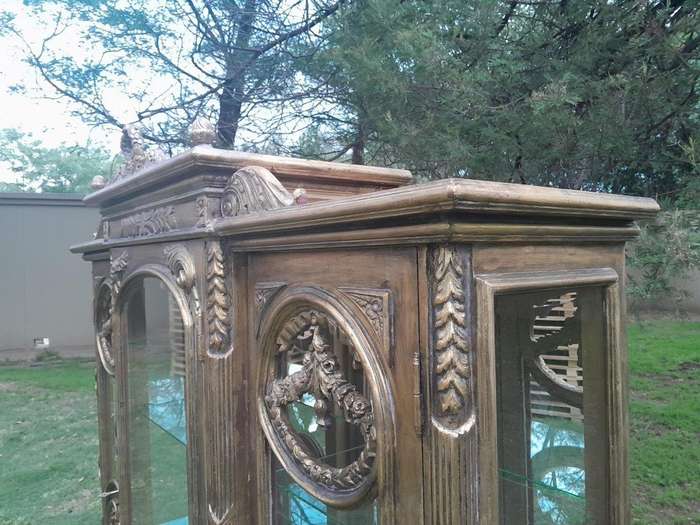 A 20th Century French Style Three Division and Large Ornately Carved and Hand-Gilded Display Cabi...