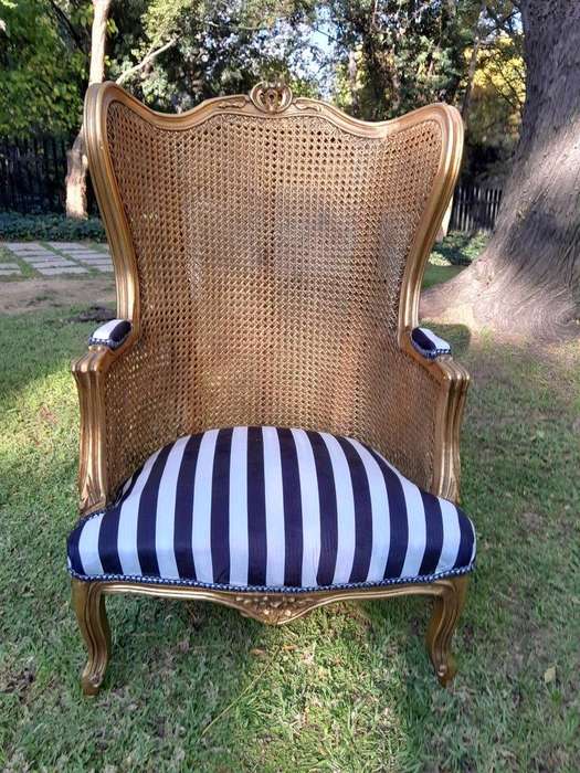 A Pair of 20th Century French Style Gilt Wood Arm Chairs with Rattan Back