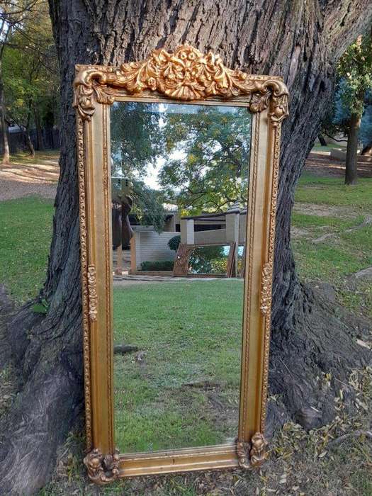 A French Style Ornately Carved and Gilded Bevelled Mirror