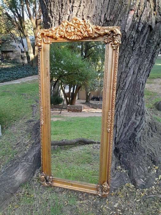 A French Style Ornately Carved and Gilded Bevelled Mirror