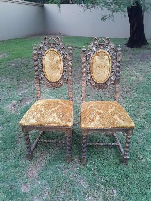 A Pair of 19th Century French Ornately Carved and Gilded Chairs