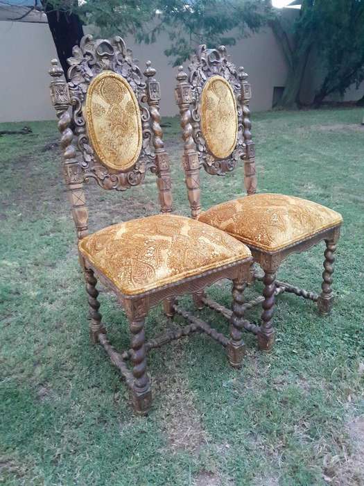A Pair of 19th Century French Ornately Carved and Gilded Chairs