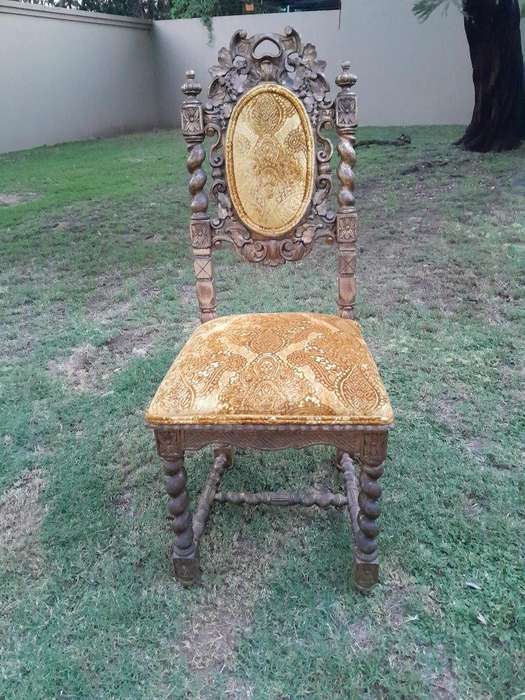 A Pair of 19th Century French Ornately Carved and Gilded Chairs