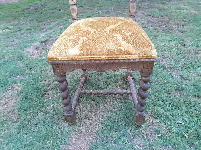 A Pair of 19th Century French Ornately Carved and Gilded Chairs