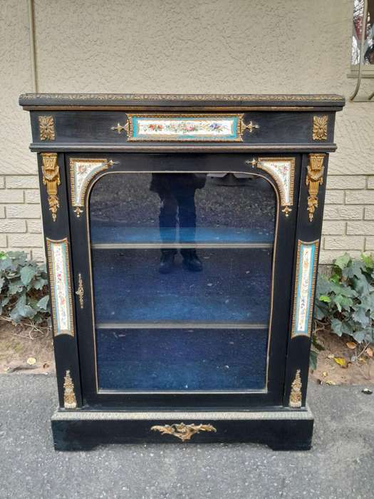 A 19th Century French Ebonised Pier Cabinet And Ormolu Mounts And Porcelain