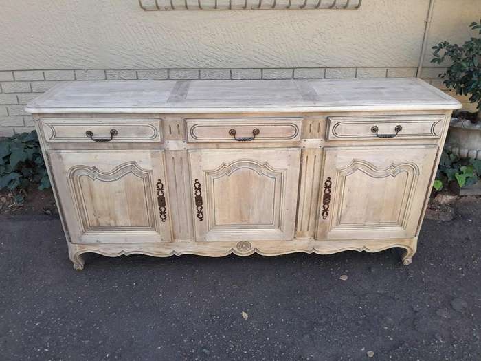 A 20TH Century French Walnut Sideboard with Original Iron hinges in a Contemporary Bleached Finish