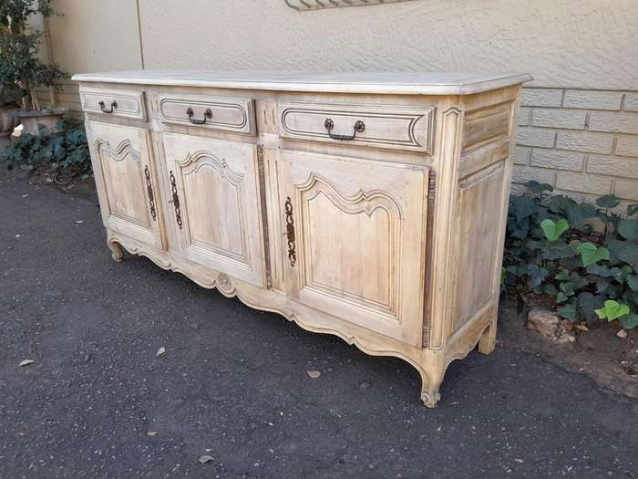 A 20TH Century French Walnut Sideboard with Original Iron hinges in a Contemporary Bleached Finish