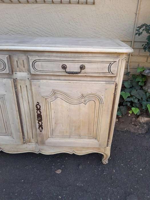 A 20TH Century French Walnut Sideboard with Original Iron hinges in a Contemporary Bleached Finish
