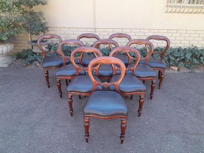 An Early 20th Century Victorian Set Of Ten Bustle Back Chairs Upholstered In Deep Button Leather