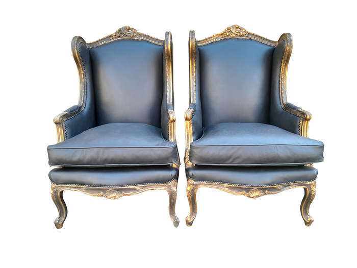 A Circa 1900s French Style Pair Of Carved Giltwood Wingback Chairs Upholstered In Leather