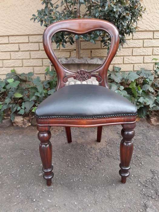 A 20th Century Set of Fourteen (14) Victorian Style Mahogany Bustle Back Chairs Upholstered in Le...