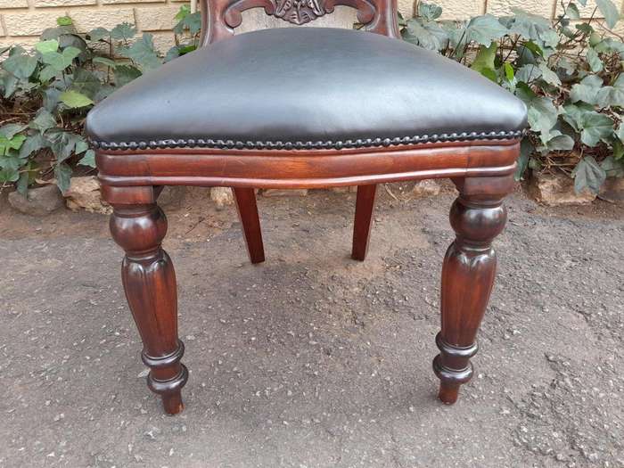 A 20th Century Set of Fourteen (14) Victorian Style Mahogany Bustle Back Chairs Upholstered in Le...
