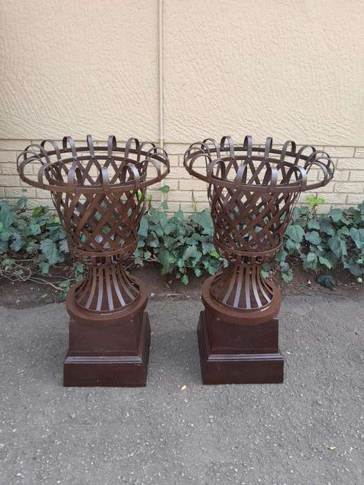 A 20th Century Pair of Decorative Wrought Iron Urns on Plinths