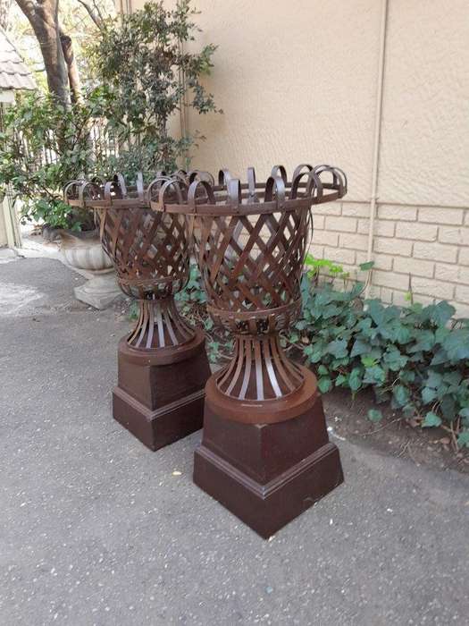 A 20th Century Pair of Decorative Wrought Iron Urns on Plinths