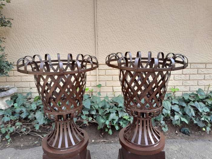 A 20th Century Pair of Decorative Wrought Iron Urns on Plinths