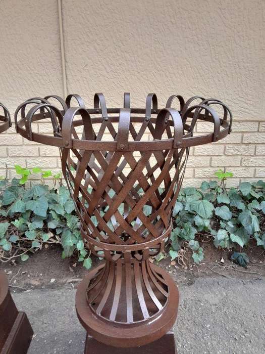 A 20th Century Pair of Decorative Wrought Iron Urns on Plinths